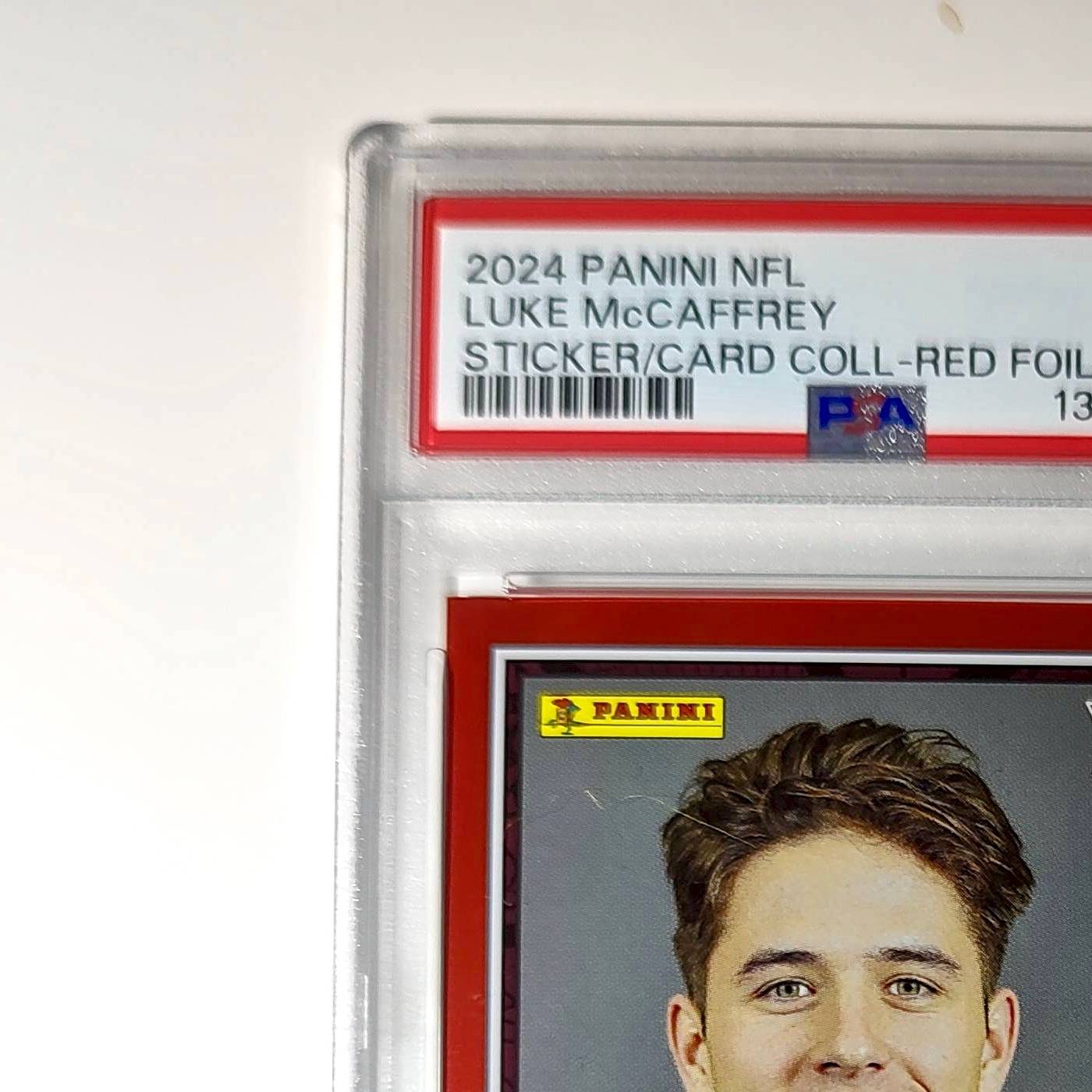 Luke McCaffrey 2024 Panini Sticker Collection 239/299 #99 Rookie Red Foil PSA 8