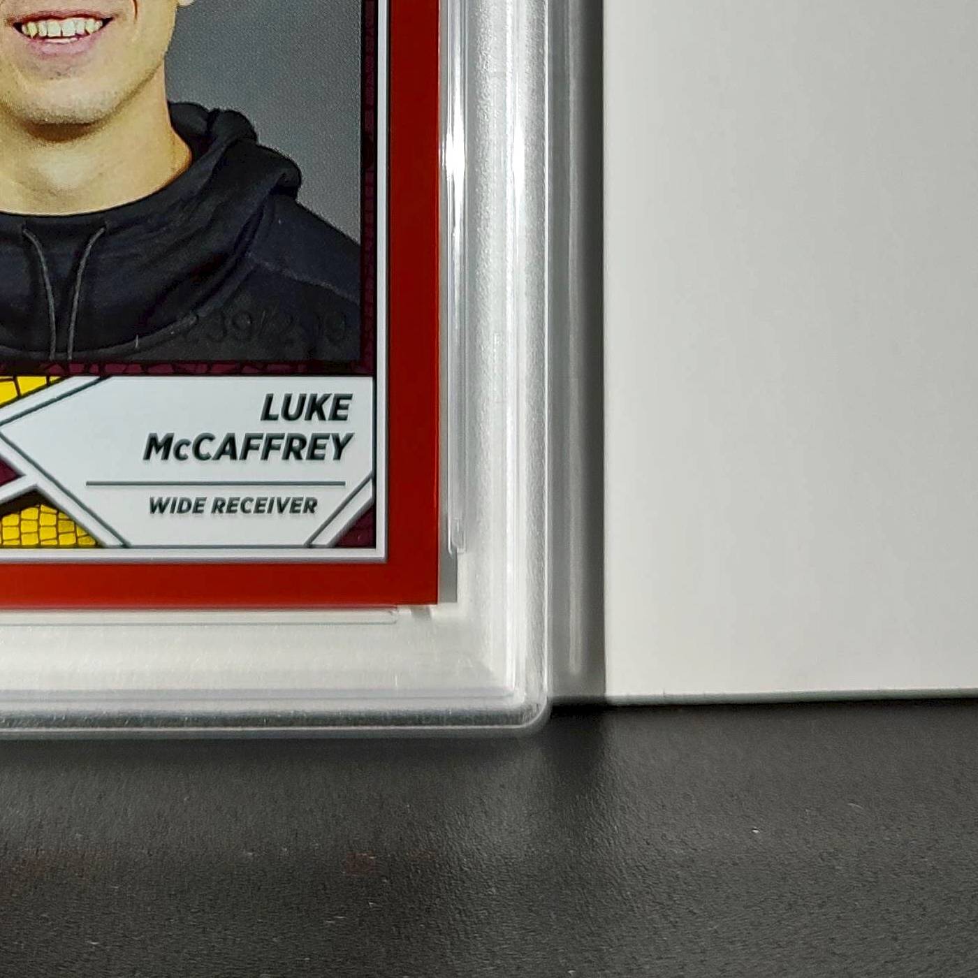 Luke McCaffrey 2024 Panini Sticker Collection 239/299 #99 Rookie Red Foil PSA 8